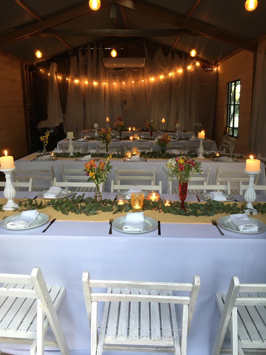 The Barn set with long tables and string lights